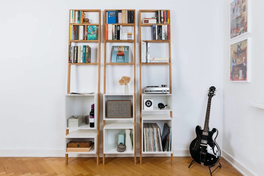 Ladder bookshelves and guitar inside the room