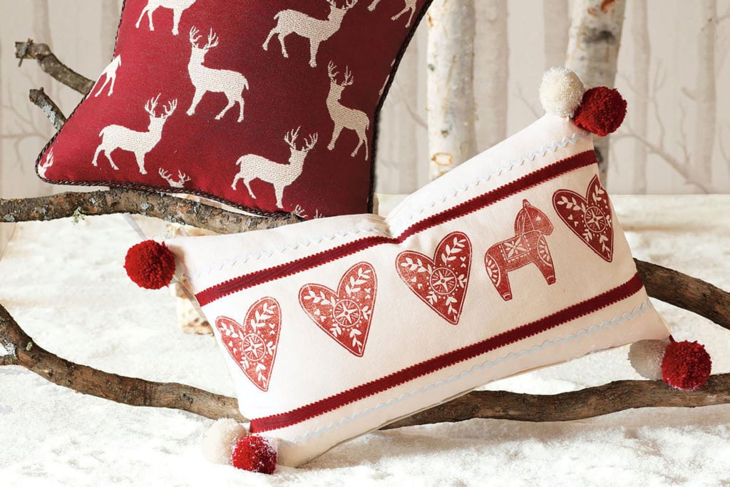 Two christmas pillows, twigs in white background