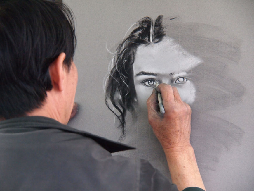Man doing charcoal drawing