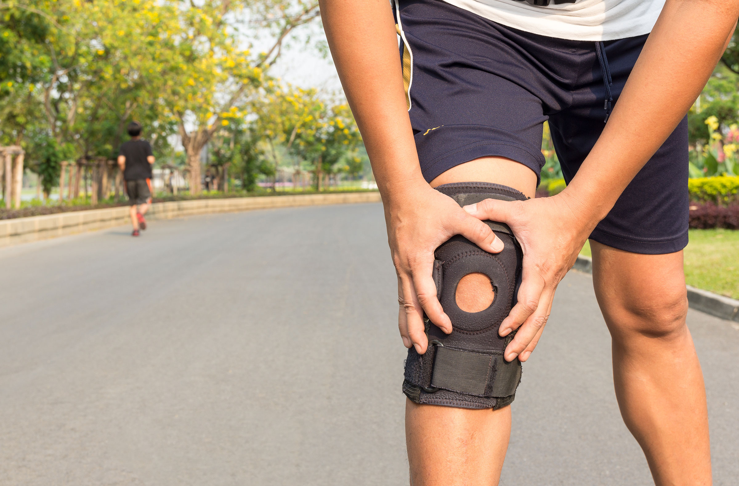 Crop image of man's knee with knee braces