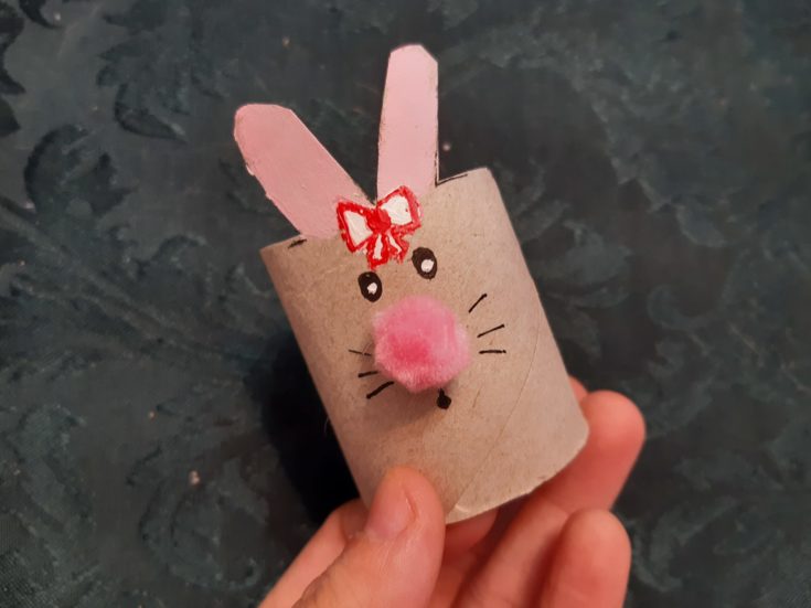 Cardboard tube bunny with glued pink pom pom nose.