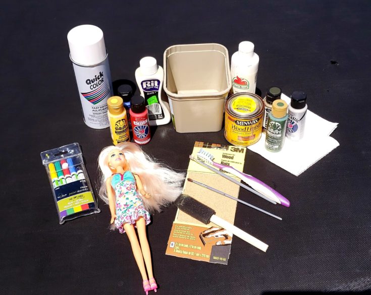 Materials needed for DIY Barbie Zombie - Plastic Doll + Plastic Tub + Dye/Stain Paints + Small Paint Brush + Acrylic Paints + Gray Spray Paint + Paper Towels