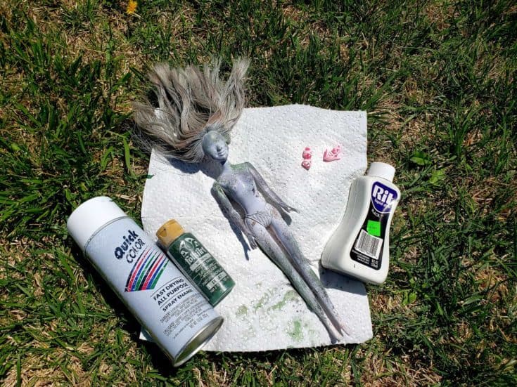 Barbie doll spray with gray paints.