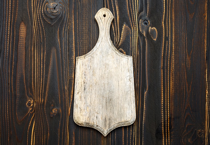 Empty vintage cutting board on wooden background