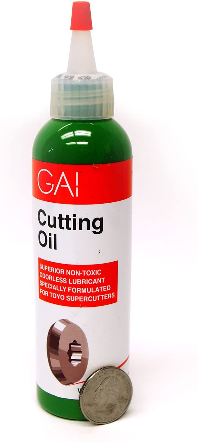 Gai Cutting Oil - 4 Oz with a coin on the side.