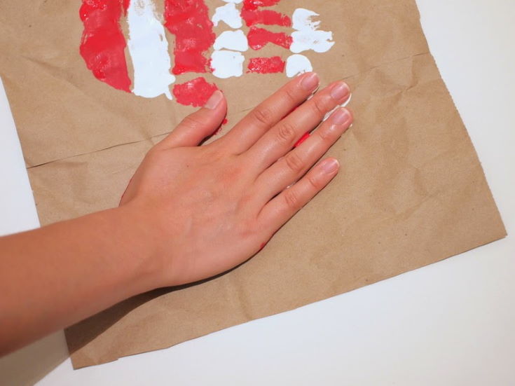 woman's hand making American Flag Hand print Heart Art