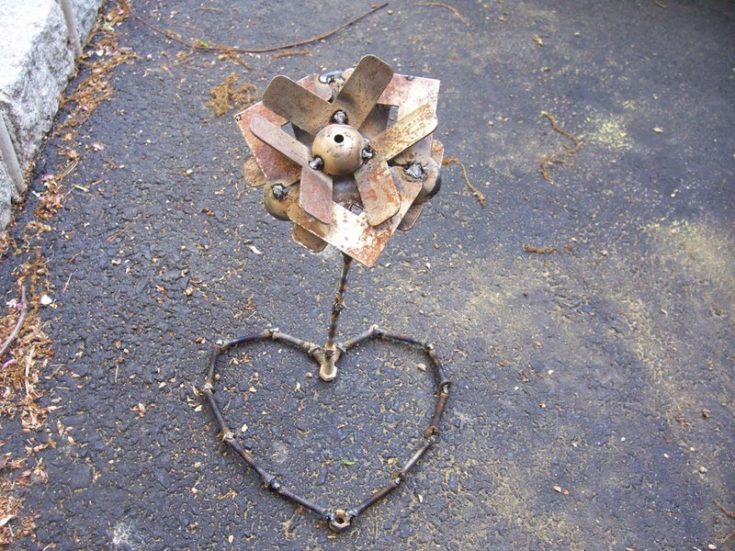 DIY metalwork flower on the ground.