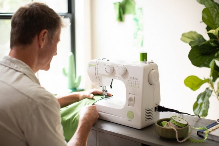 a man using the Baby Lock Zest Sewing Machine