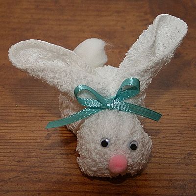 Adorable cute little rabbit project on a wooden background.