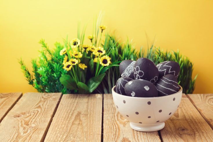 Easter eggs painted with chalkboard paint on wooden table