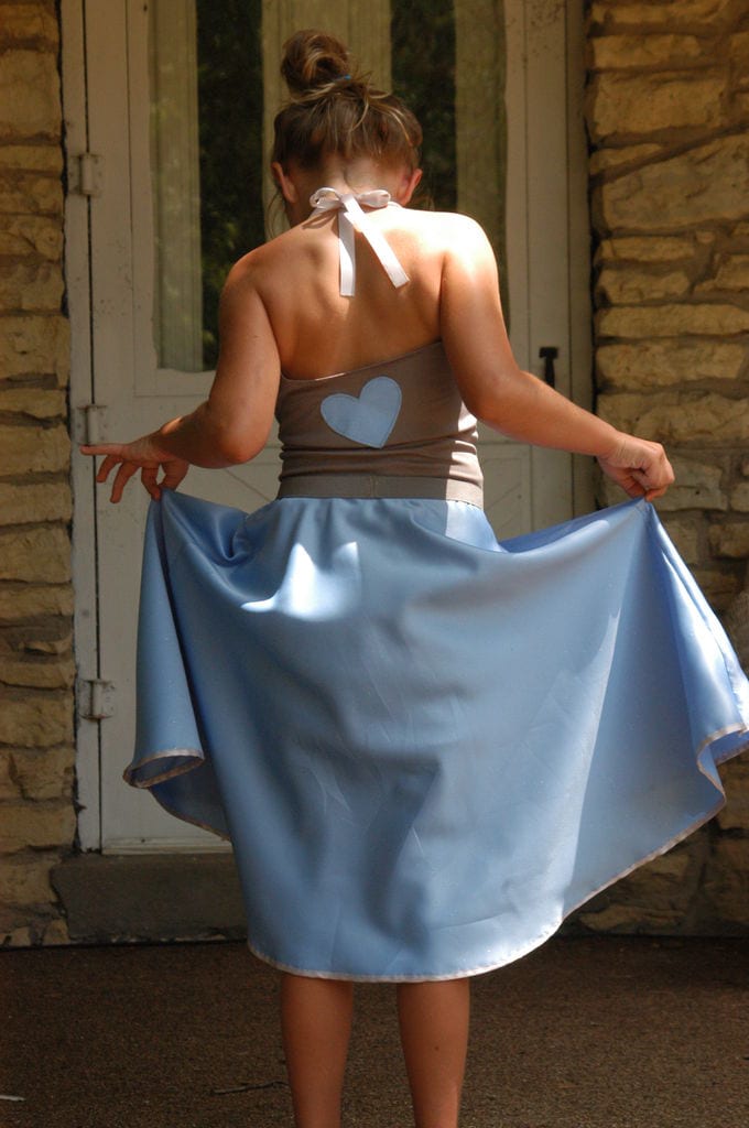 a girl wearing a powedered blue Circle Skirt, rear shot