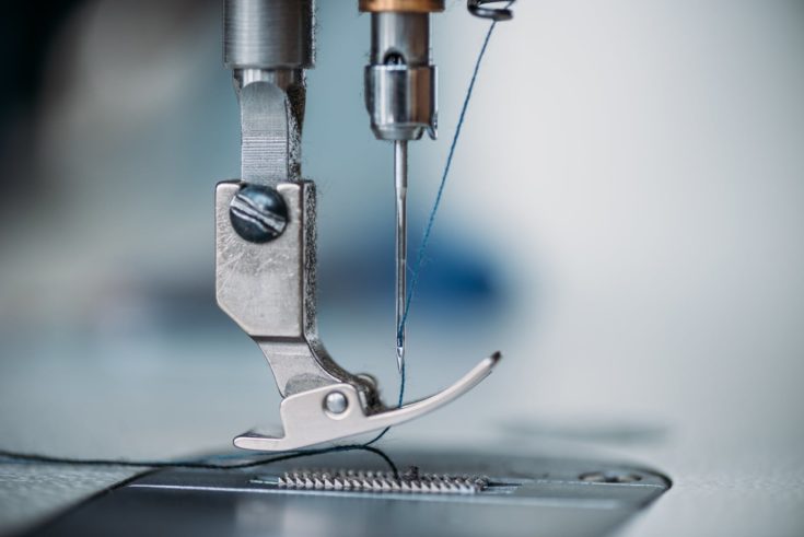 Close-up shot of needle and thread of sewing machine