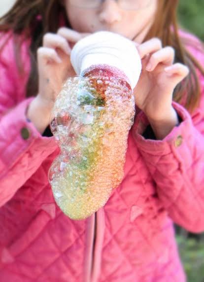 selective focus of DIY Bubble Snakes used by a young girl