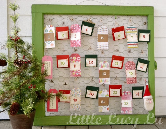 Country advent calendar in colorful envelopes hanged in wire in a green frame