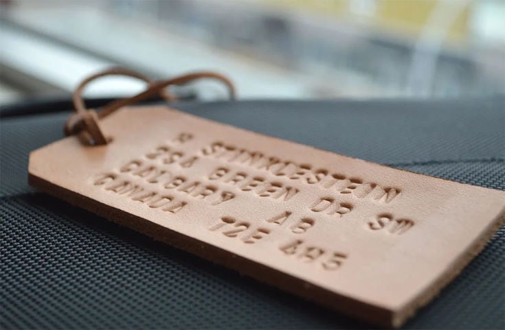 Embossed Leather Luggage Tag in leather black background