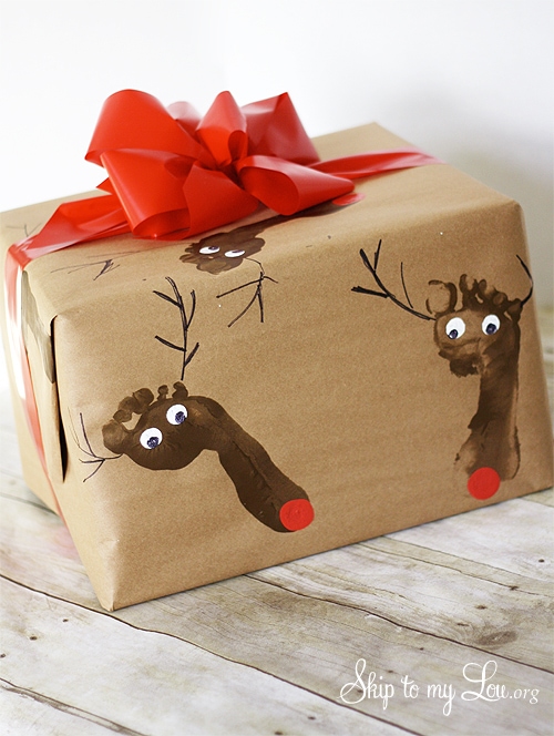 Brown wrapping paper with kid footprint and red ribbon by Skip to my Lou