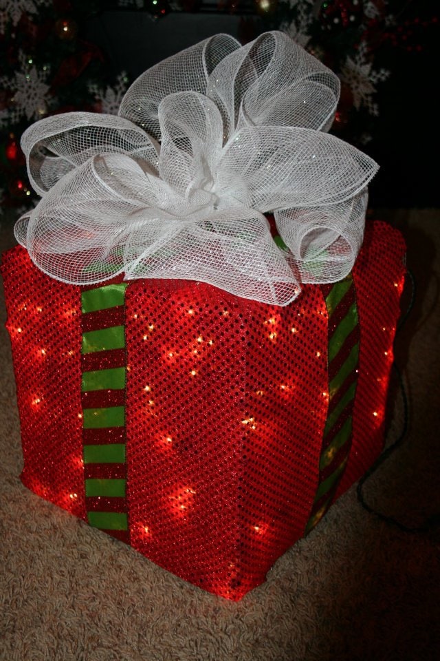 Lighted Christmas present red box tied white ribbon on top