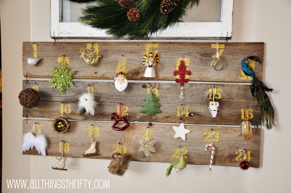 All Things Thrifty DIY three plank wood advent calendar with different ornaments hang