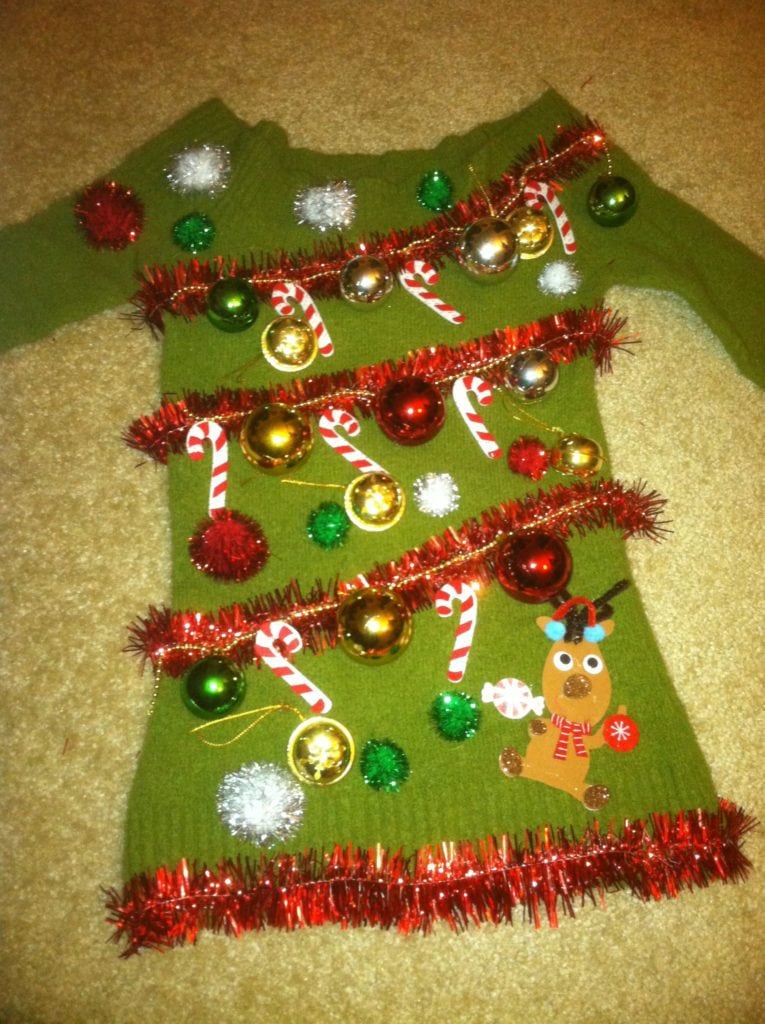 Green sweater with red garlands, balls, candy cane and reindeer
