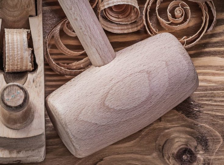 Chisels shaving plane shavings wooden mallet on wood board construction concept.