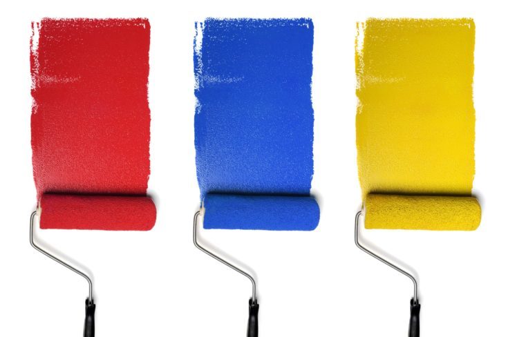 Paint Rollers with primary colors isolated over white background