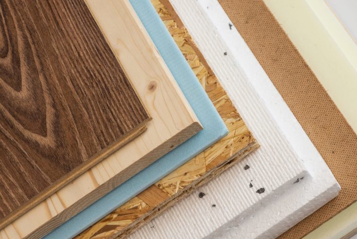 Stack of various construction supplies. Insulation foams and wood boards.