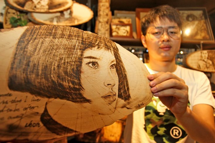 27-year-old Chinese man Peng Fang displays an art work of pyrography at his shop in Xi'an city, northwest China's Shaanxi province, 23 July 2018. Pyrography, which means writing or painting with fire, is the art of decorating wood or other materials with burn marks resulting from the controlled application of a heated object such as a poker. Peng Fang, a post-90s man, has loved pyrography for a long time. He is dedicated to improving and promoting pyrography, opening a pyrography art shop in Xi'an city, northwest China's Shaanxi province.