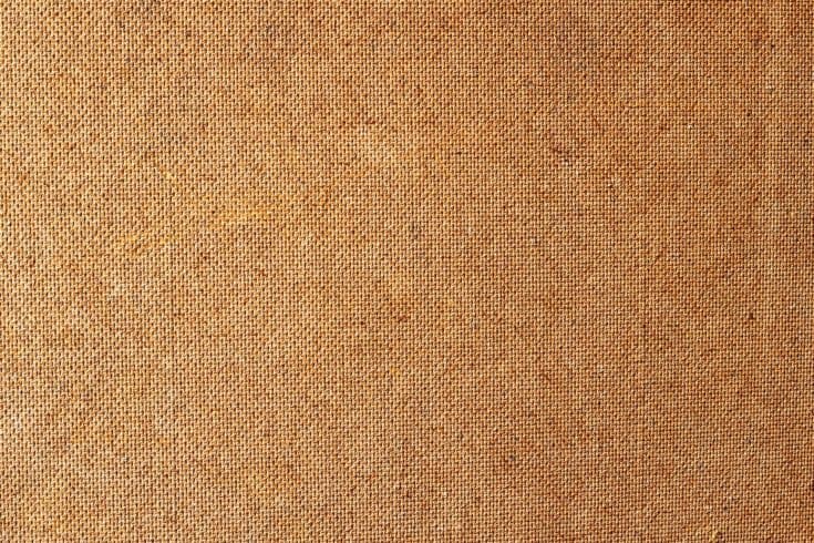 Hardboard backside background image. Background paintings from fiberboard. Fibrous leaf leaf back side texture. A closeup shot of a fiber surface texture. Fiberboard back wallpaper