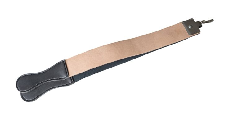 Genuine leather strop ore belt for sharpening razor isolated on a white background