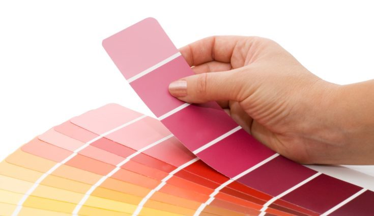 Woman hand pointing to a sample color chart