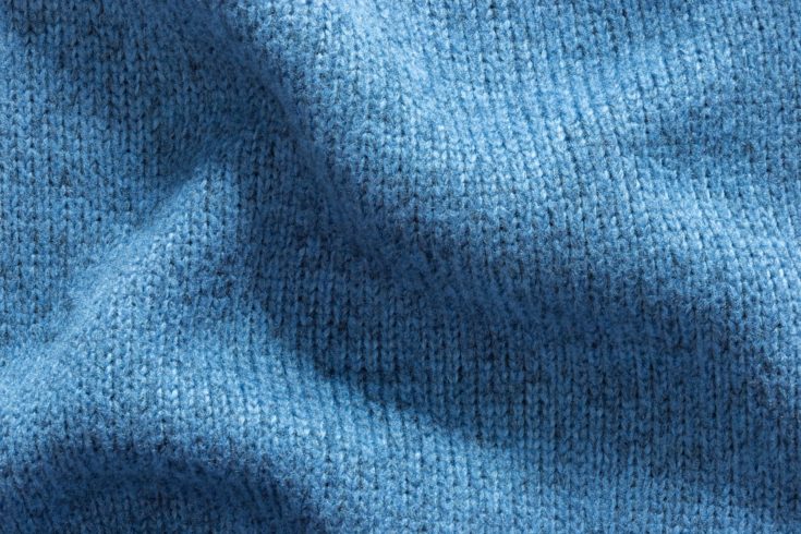 Texture background of blue polyester fabric sweater