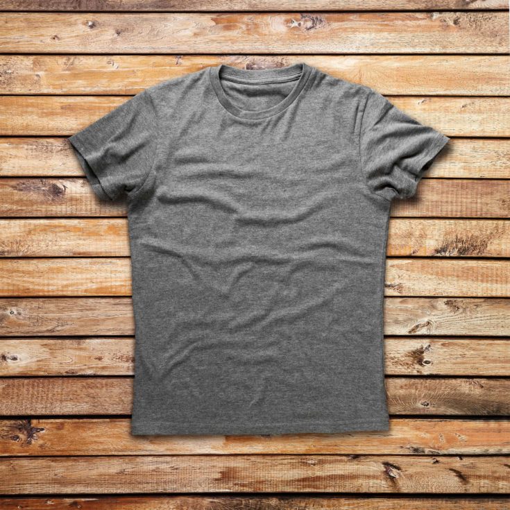 Gray cotton t-shirts on a wooden background.