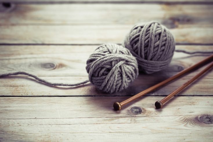 Balls of wool on old wooden background