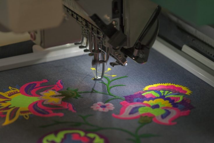 Professional machine for applying embroidery on different tissues closeup