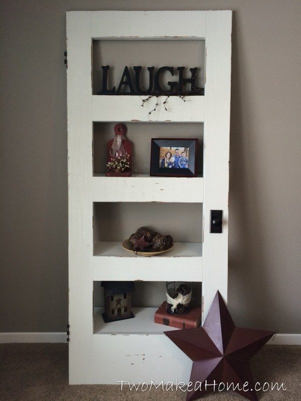 Two Make a Home old door made as shelves with word laugh on the top shelf