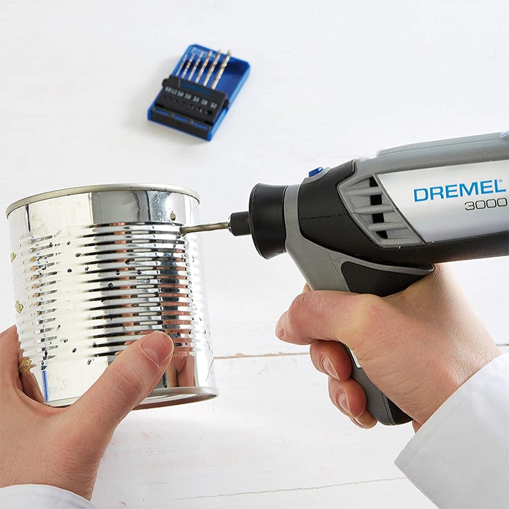 man's hand using Dremel on the can