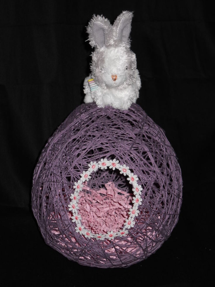 Easter Egg Threaded Decoration with a rabbit toy at the top