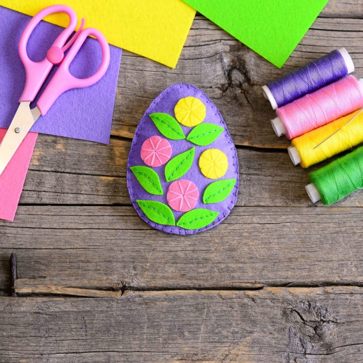 Felt Easter egg decorated with green leaves and colorful flowers