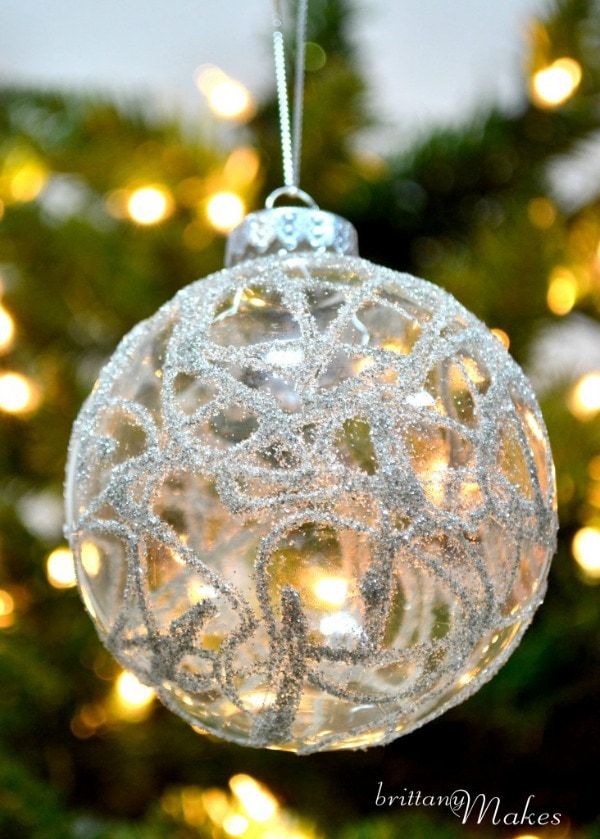 Glittered Christmas Ball Hanging on a tree Brittany Makes is Written