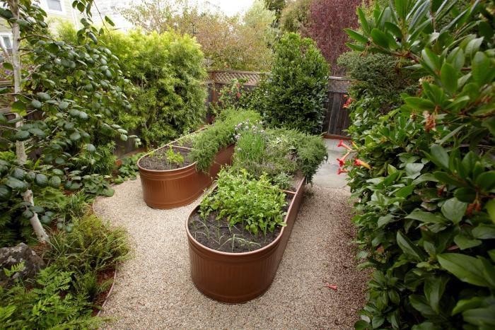 Two brass container in the middle of the garden