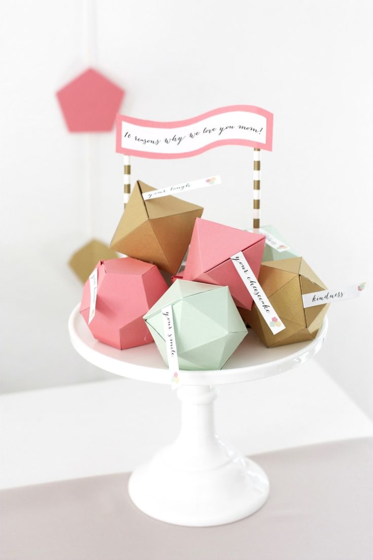 DIY geometric boxes paper crafts with tag messages on a cake stand.