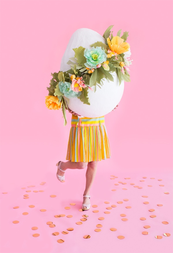 Giant Floral Easter Egg carried by a woman in pink background