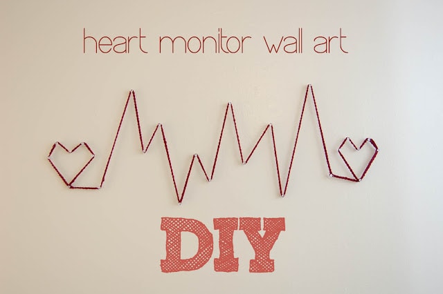 Heart monitor string art on wall.