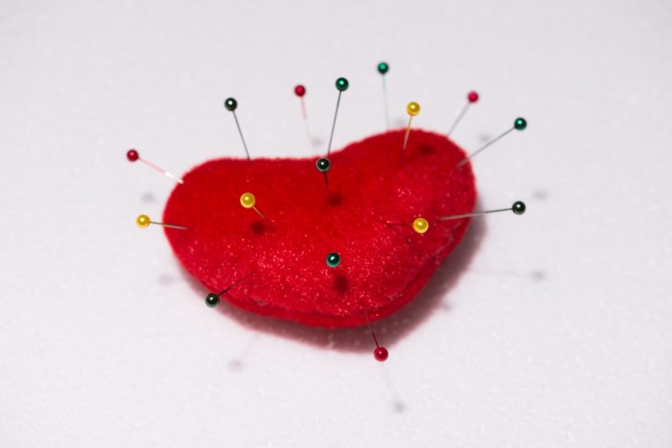 Pins sticking on heart shape cushion