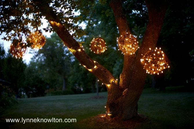 DIY Lynne Knowlton lighted grapevine balls hanging up on a tree