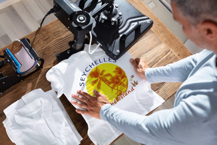 Man Printing Image On a white T-Shirt 