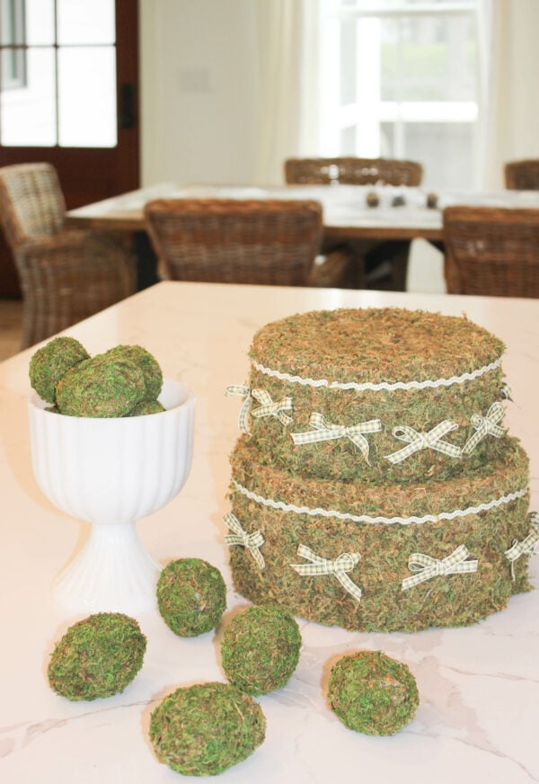 Moss Covered Eggs For Easter at the top of a white table