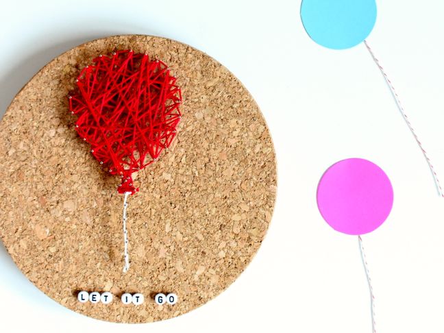 Kid friendly string art project - balloon on round cork board.