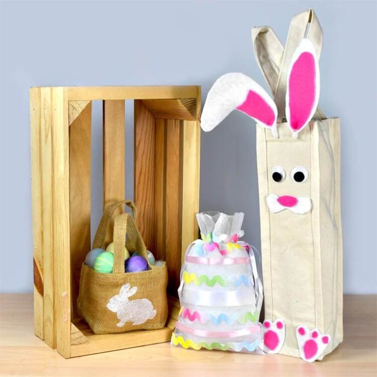 DIY goody bags with easter eggs inside displayed with the brown bag inside a wodden crate.