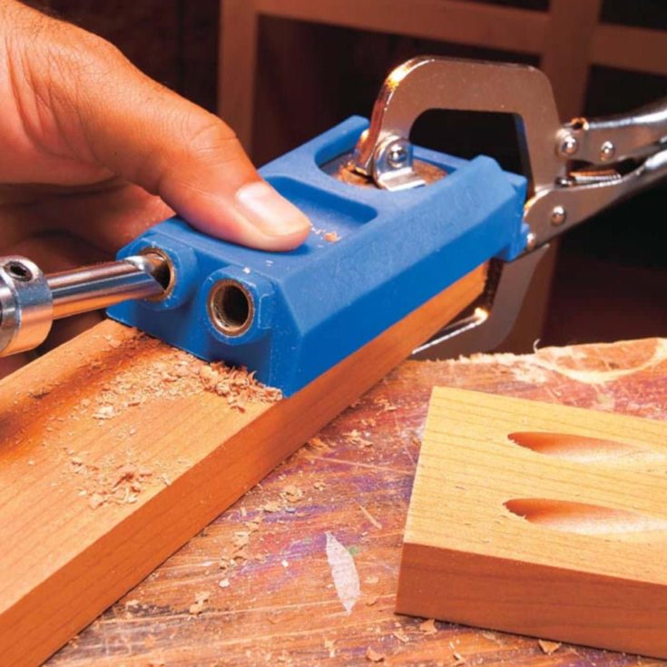 Making screw hole to the wood using a drill bit.